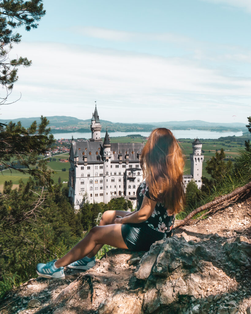 neuschwanstein castle with woman overlooking