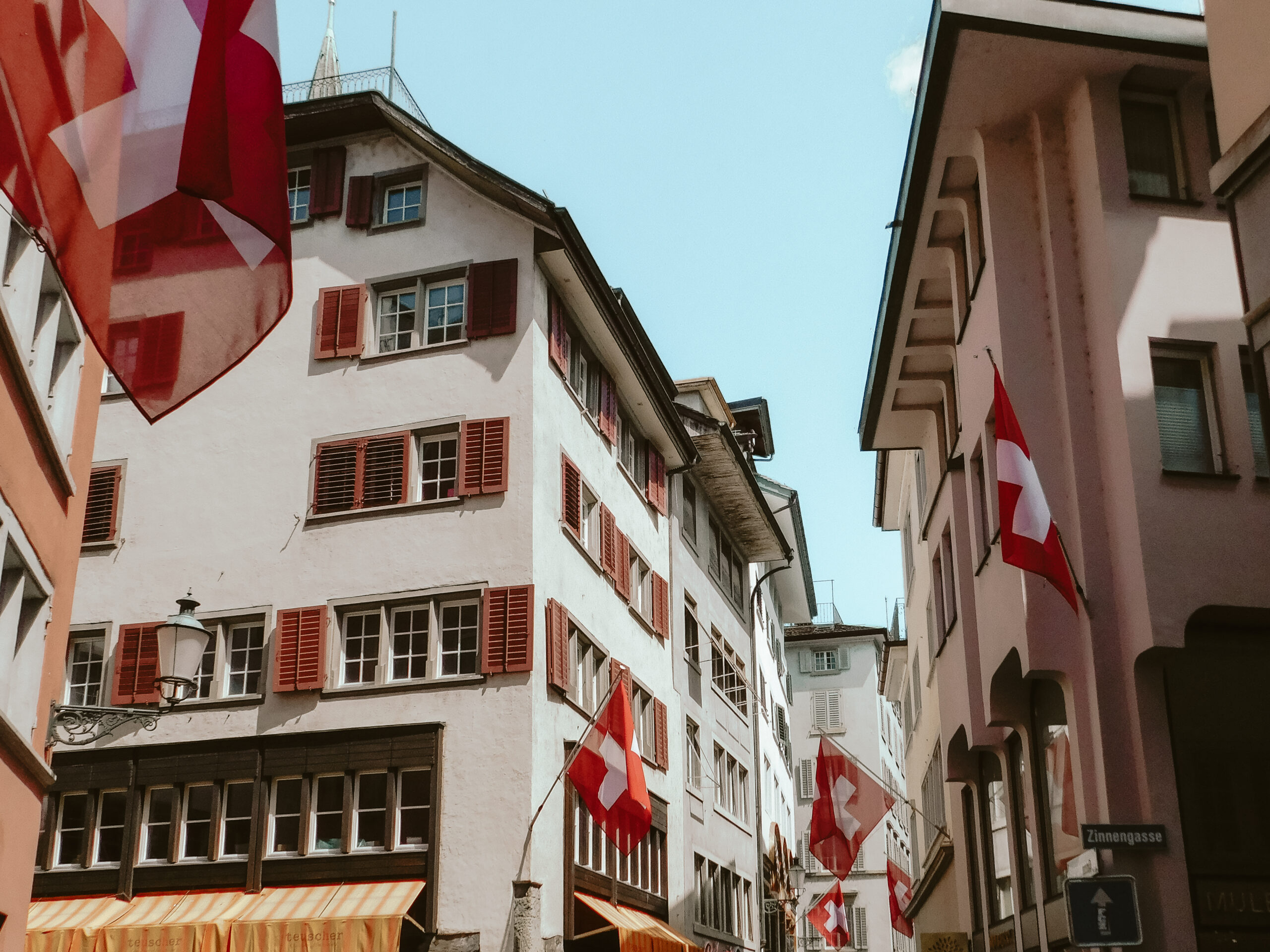 zurich downtown buildings with swiss flags