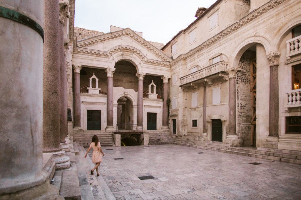 split diocletians palace early morning no crowds with woman in pink dress