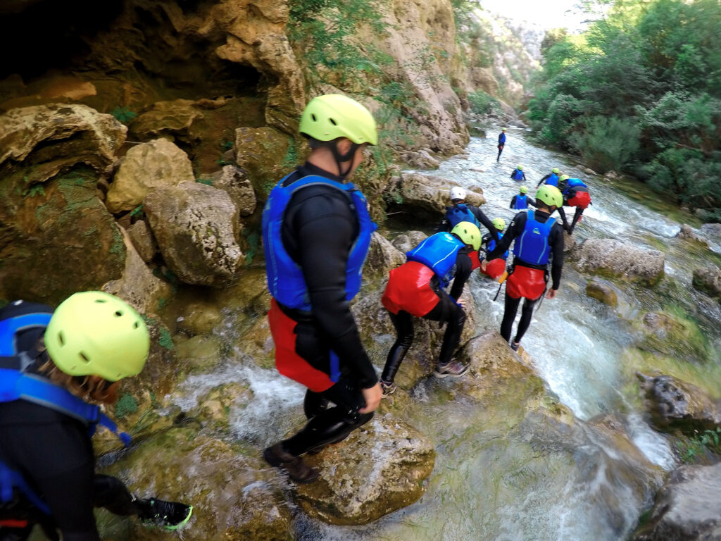 canyoning in croatia group blue life vests and yellow helmets