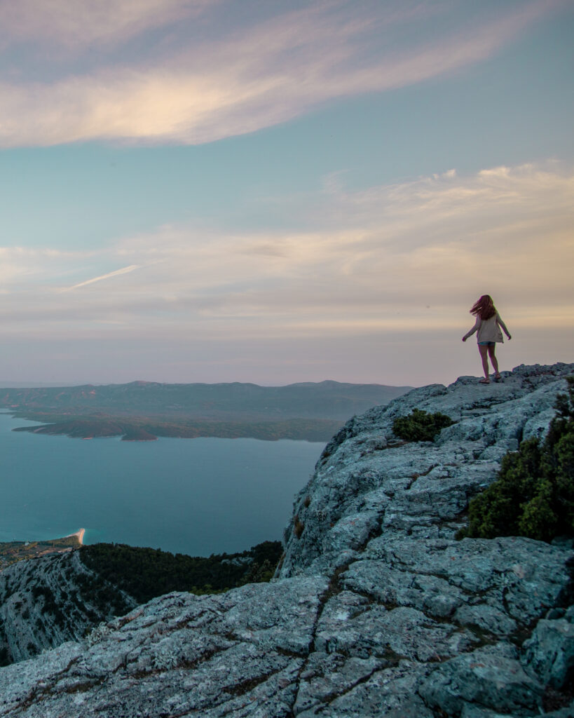 vidova gora brac island croatia with woman standing on cliff
