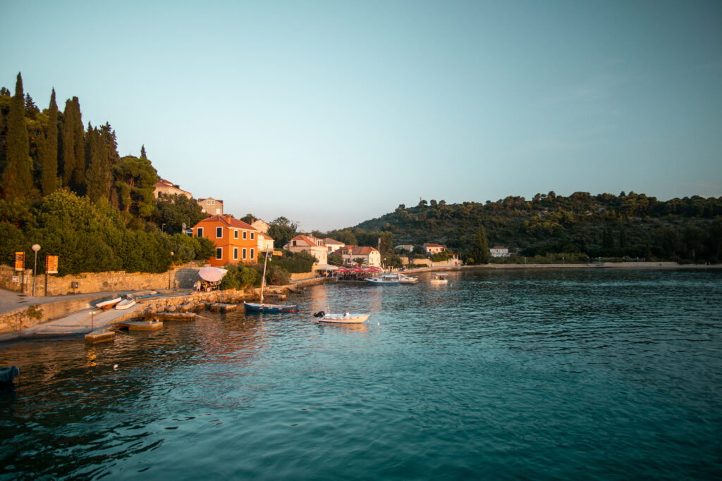 coastal view of lopud island croatia with teal water and orange buildings