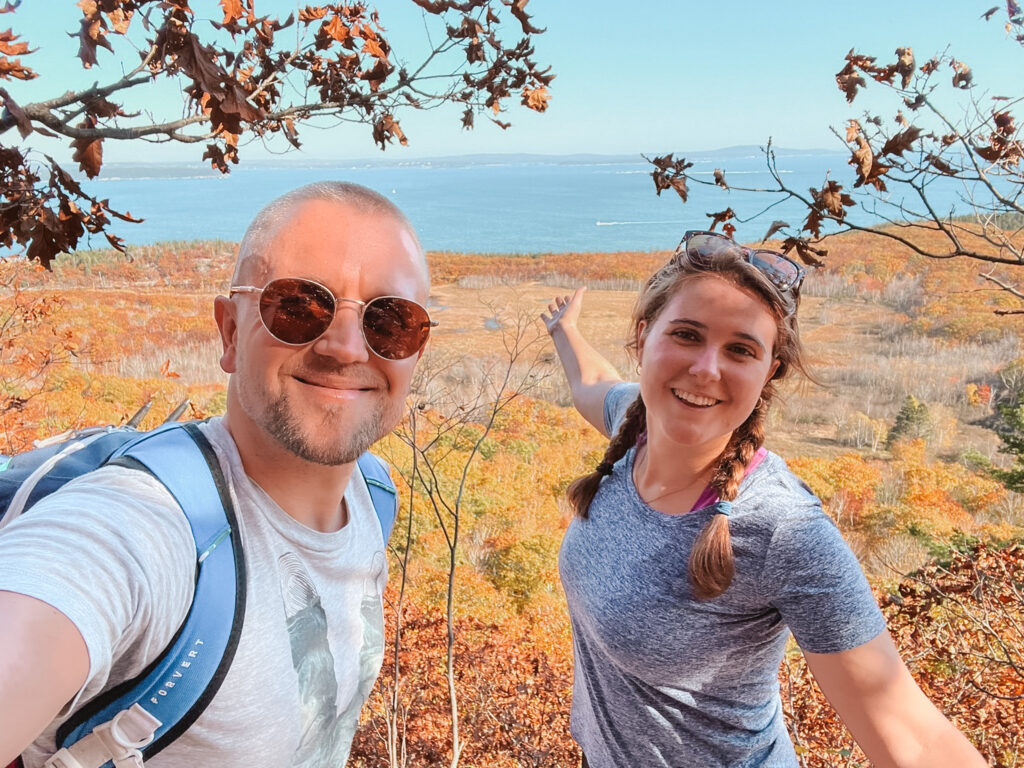 hiking couple with fall foliage in acadia